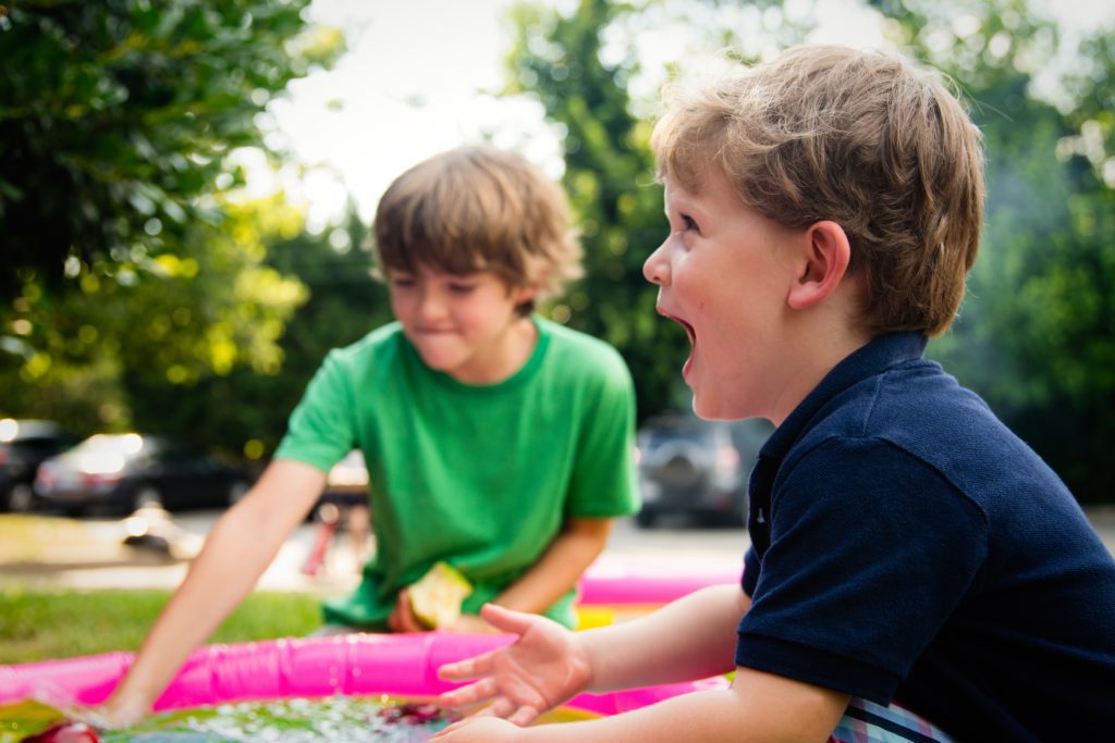 two boys playing in a park